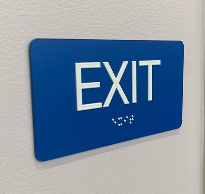 NAP TAGS ADA-compliant Exit Sign (6" x 3"). Features raised text and Braille on a blue background. Durable, easy to install, and perfect for any indoor facility.