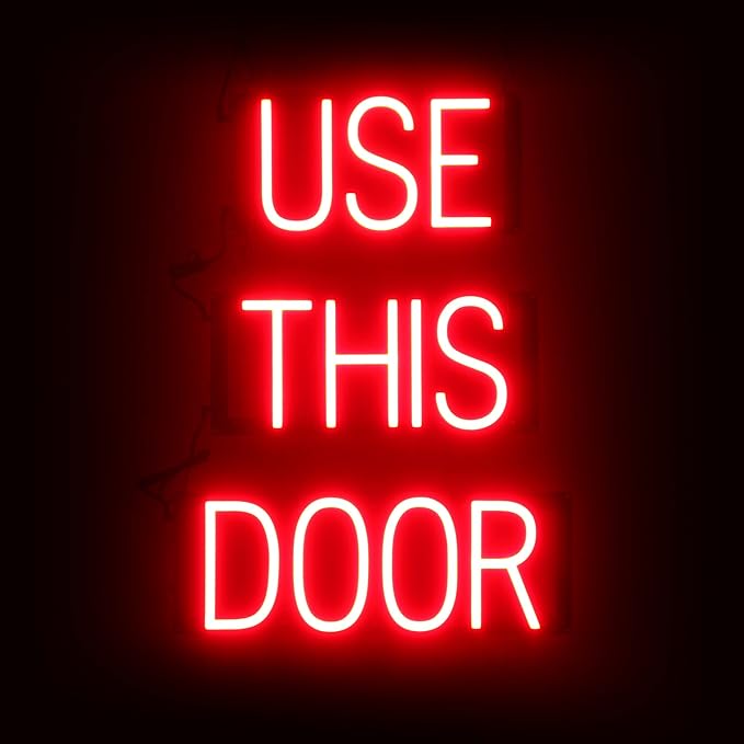 SpellBrite USE THIS DOOR Sign | Directional Sign with Neon Look, Red LED Light Source | 17.4" x 23.8"