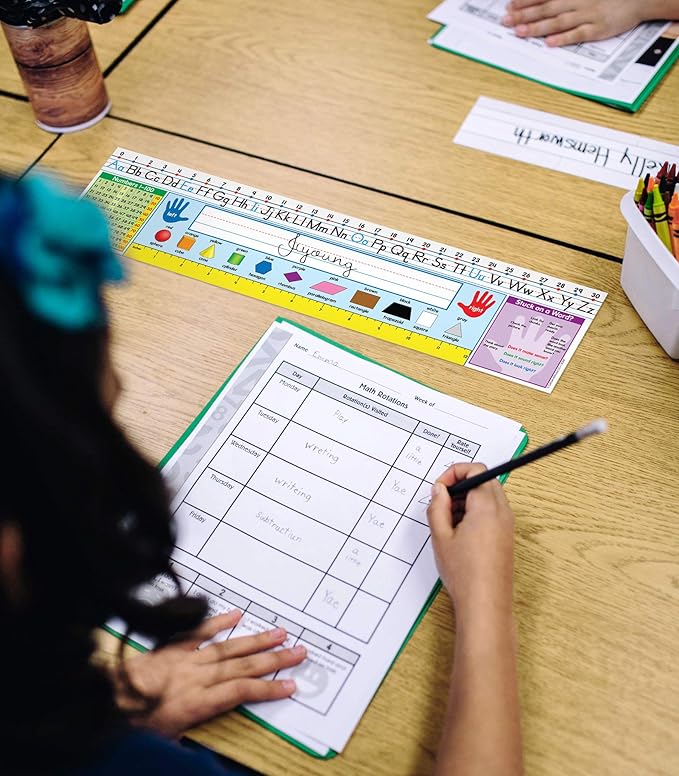 Carson Dellosa Education 30PC Quick Stick Name Plate Set offers alphabet charts, number lines, a 100 chart, a ruler, and clear labels that support organized desks and help students develop skills well